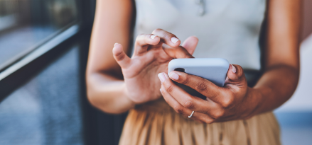 Woman contacting ExxonMobil on her smart phone